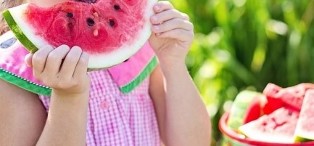 The girl eats watermelon